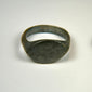 Ancient bronze oval signet ring with engraved bezel and deep olive patina, Roman to Early Medieval period