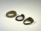 Medieval bronze finger ring displaying a solid band and weathered heart-like bezel