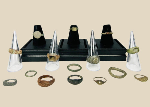 A curated collection of fifteen ancient bronze rings spanning Egypt, Rome, Byzantium, Viking, and Medieval Europe, featuring diverse patinas, signet bezels, wedding bands, and ceremonial designs, dating from 1000 BCE to the 15th century CE.