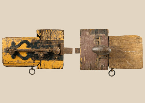 Rare 18th-century colonial wooden locking mechanism with original hand-forged iron hardware, including bolt, latch, and key ring; mounted on aged yellow-painted wood with visible wear, rusted fittings, and patina, illustrating early security technology and craftsmanship of the colonial era.