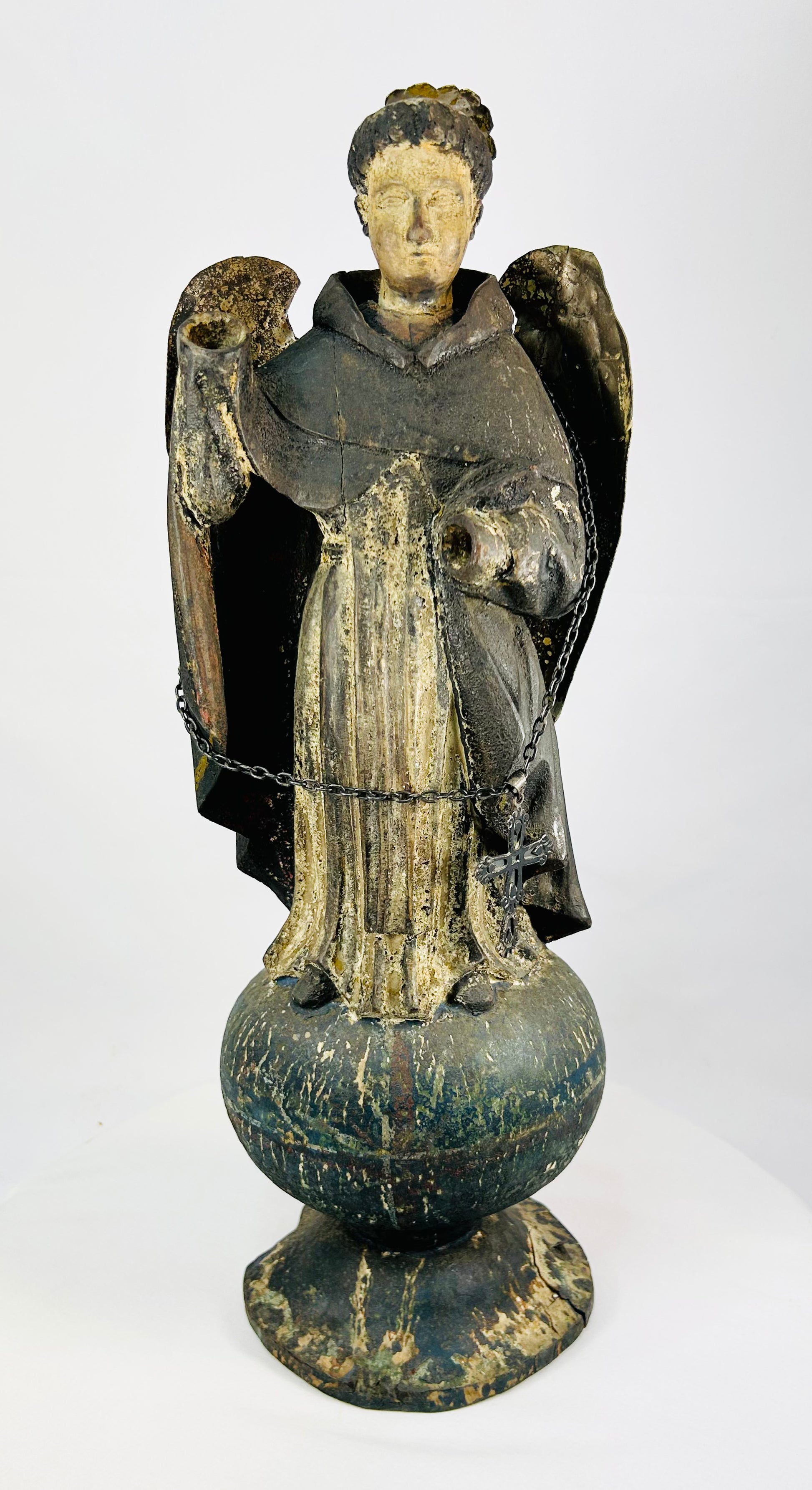 Antique Colonial Latin American polychrome wooden angel or saint figure, 18th–19th century, standing on orb base, gilded wings, remnants of original painted surface, later added sterling silver chain and cross marked 'Sterling, Mexico', traditional folk-religious craftsmanship
