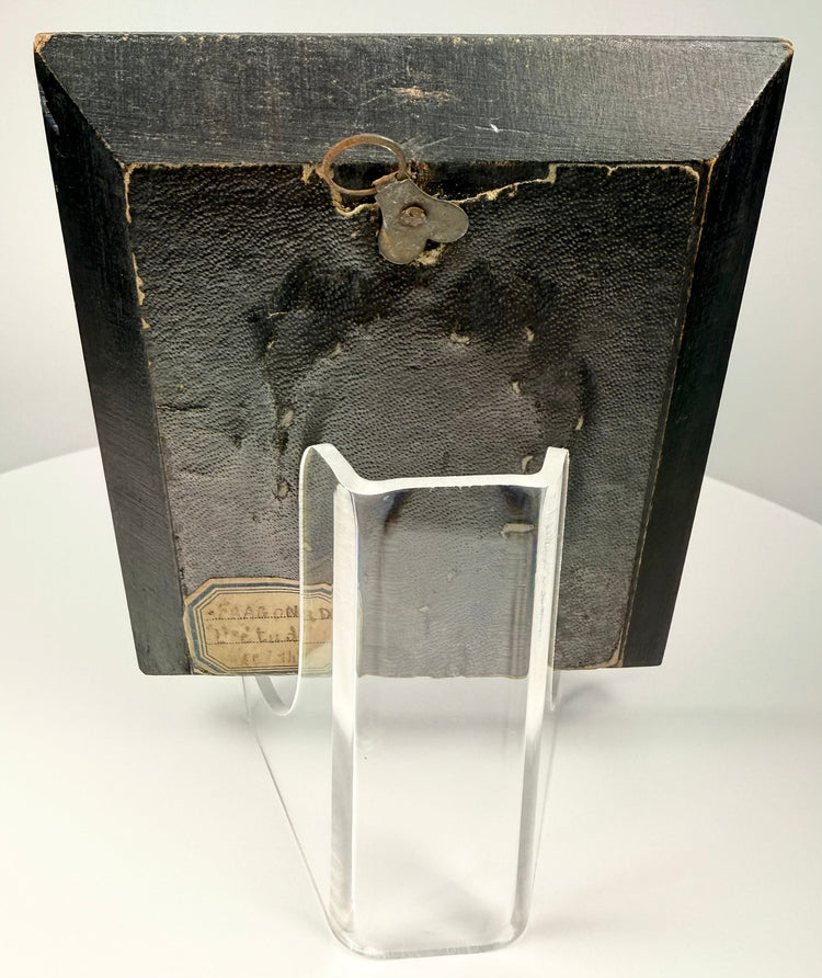 Rear view of worn ebonized frame with metal ring for hanging