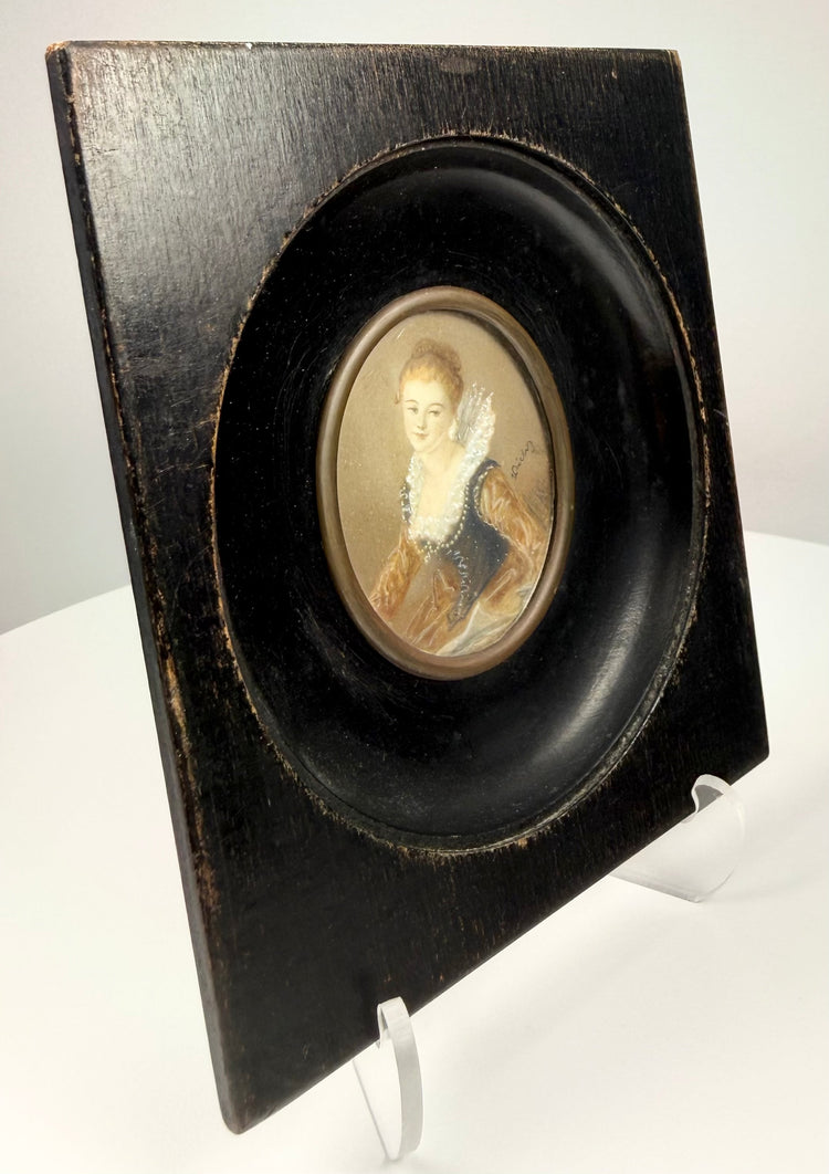 Angled view of ebonized wooden frame depth holding miniature portrait