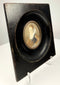 Angled view of ebonized wooden frame depth holding miniature portrait