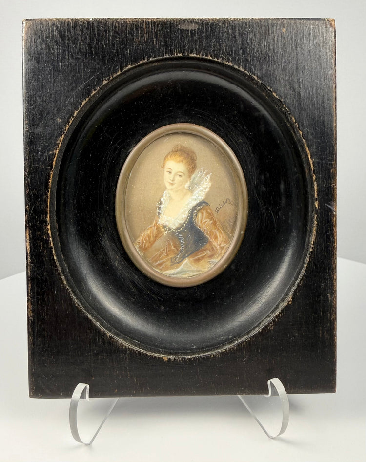 Frontal shot of 19th century miniature painting of woman in blue bodice