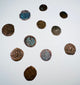 Medieval bronze coins displaying Christian crosses and remnants of period inscriptions