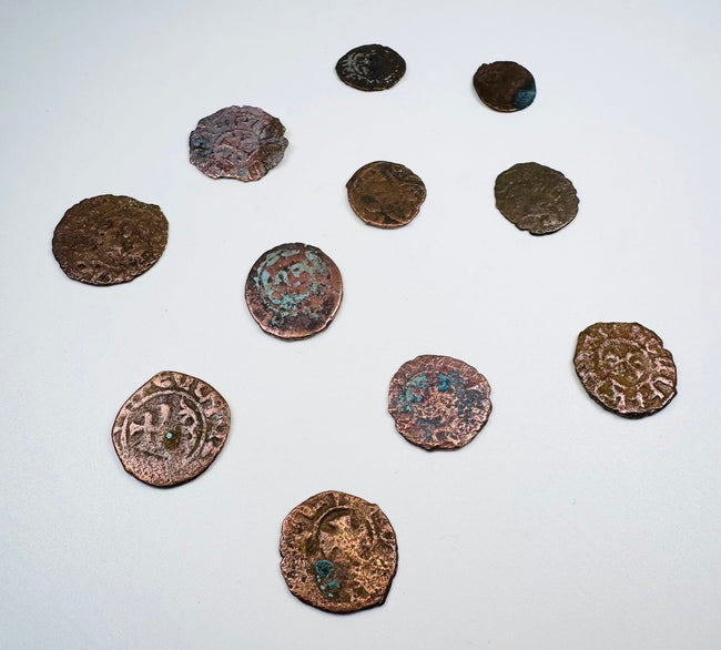 Eleven historic Levantine coins showing varied sizes, shapes, and struck designs