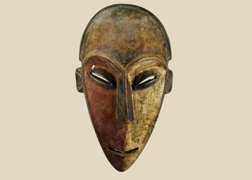 Authentic Dan tribal mask from Côte d’Ivoire, carved wood with dual-tone pigments, elongated eyes, and patina from ritual use, circa 1930–1950.