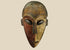 Authentic Dan tribal mask from Côte d’Ivoire, carved wood with dual-tone pigments, elongated eyes, and patina from ritual use, circa 1930–1950.