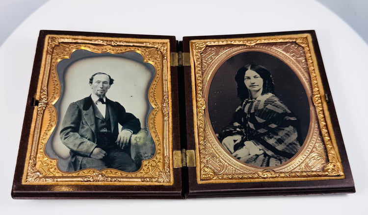 Antique Victorian ambrotype portrait pair with gilt brass mats and velvet lining