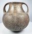 Ancient Etruscan terracotta amphora showing its rounded body, high loop handles, short neck, and dark impasto surface.