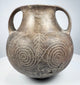 Ancient Etruscan terracotta amphora showing its rounded body, high loop handles, short neck, and dark impasto surface.
