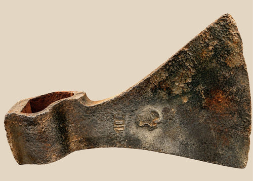 Early modern European hand-forged iron axe head with wedge-shaped blade and visible hammer marks