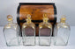 Early 19th century Georgian mahogany spirit box with four parcel-gilded glass decanters and red fitted interior