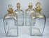 Georgian glass spirit decanters showing square bottle forms, gilt detailing and original fitted stoppers