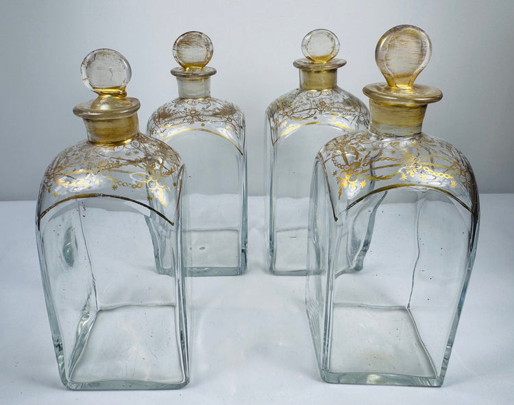 Georgian glass spirit decanters showing square bottle forms, gilt detailing and original fitted stoppers