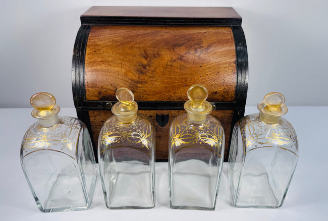 Antique Georgian boxed decanter set with mahogany case, four square glass spirit decanters and gilt stoppers