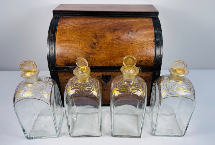 Antique Georgian boxed decanter set with mahogany case, four square glass spirit decanters and gilt stoppers