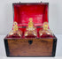 Georgian spirit box with four square glass decanters displayed beside the open mahogany carrying case