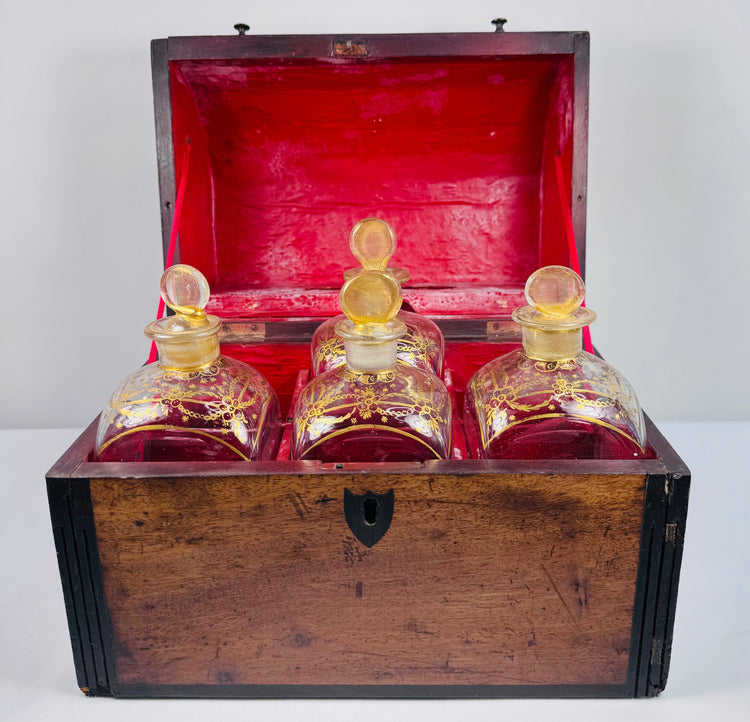 Georgian spirit box with four square glass decanters displayed beside the open mahogany carrying case
