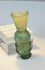 Small blue-green glass unguent vessel with raised horizontal mouldings and foot