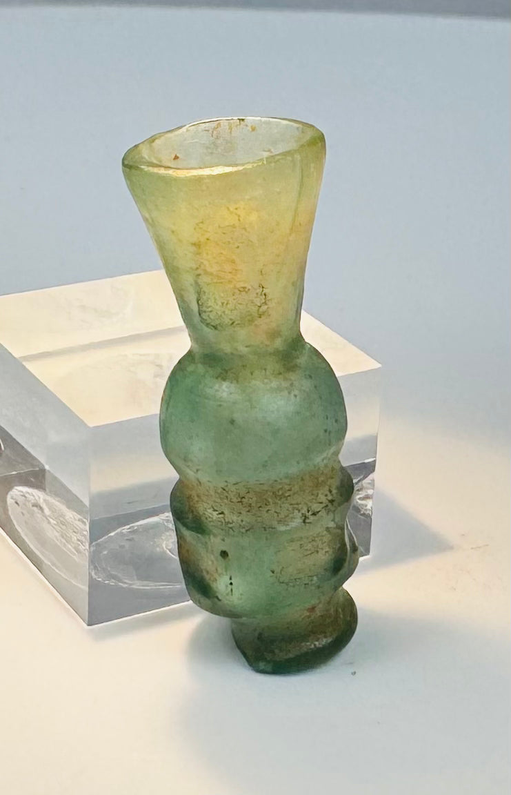 Small blue-green glass unguent vessel with raised horizontal mouldings and foot