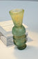 Small blue-green glass unguent vessel with raised horizontal mouldings and foot
