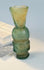Early Islamic miniature glass container with cloudy translucency and mineral staining