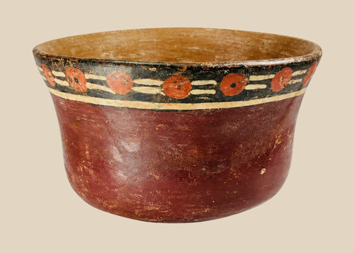 Early Nazca terracotta bowl, circa 100–300 AD, with flared rim and vibrant polychrome decoration of red circular and black-cream geometric motifs, reflecting pre-Columbian ceremonial artistry.