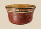 Early Nazca terracotta bowl, circa 100–300 AD, with flared rim and vibrant polychrome decoration of red circular and black-cream geometric motifs, reflecting pre-Columbian ceremonial artistry.