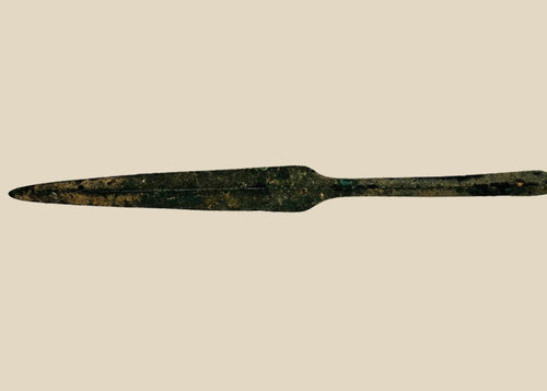 Ancient Cypriot bronze spearhead from the Early Bronze Age, Early Cypriot III period (c. 2500–1900 BCE). Leaf-shaped blade with raised central ridge, straight tang, and four-sided midsection for strength. Functional and ceremonial weapon reflecting Bronze Age metallurgy, hunting, and martial traditions in Eastern Mediterranean societies.