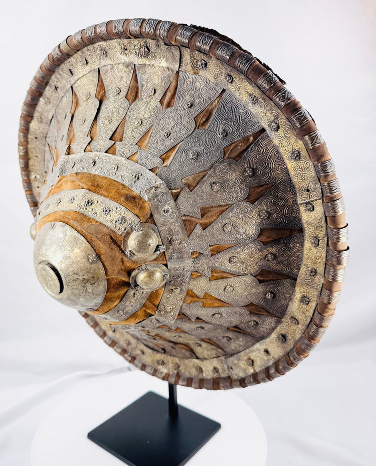 Side profile of an antique Ethiopian shield displaying its deep convex construction
