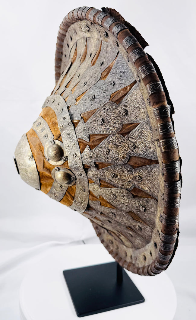 Side view of the red leather-backed Ethiopian ceremonial shield on display stand