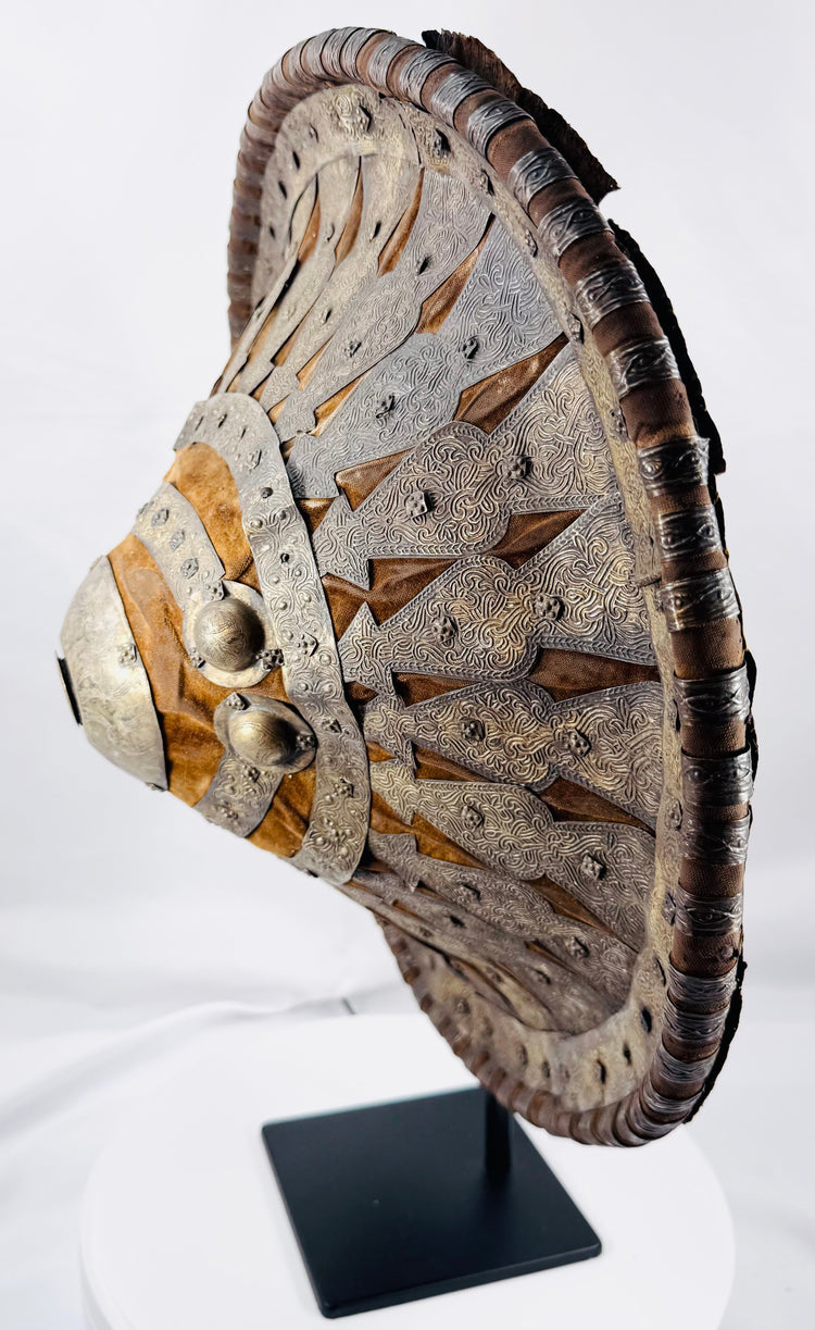 Side view of the red leather-backed Ethiopian ceremonial shield on display stand