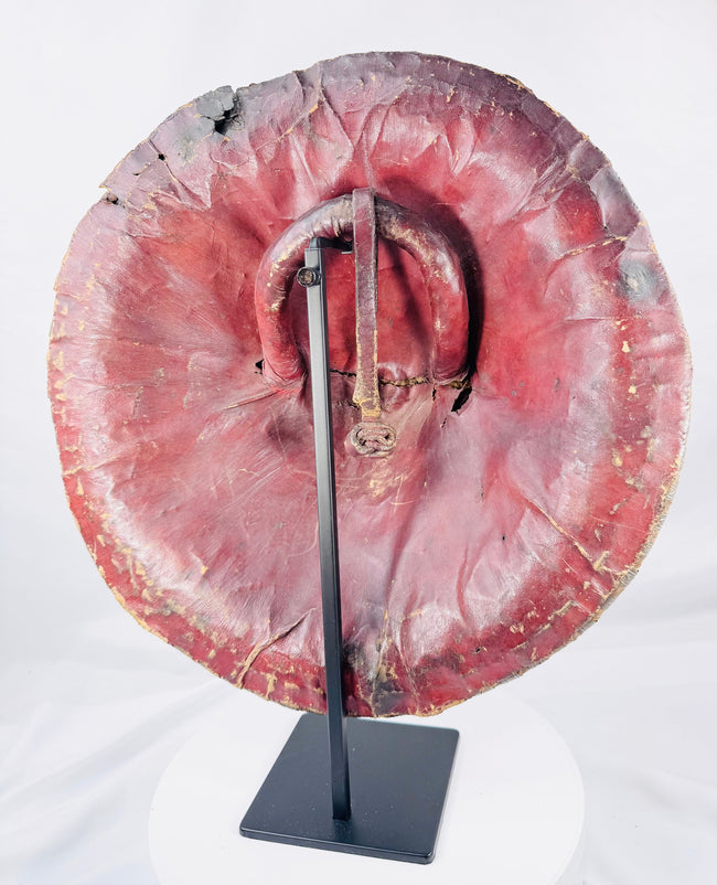 Rear view of an Ethiopian hide shield covered in red leather with original handgrip