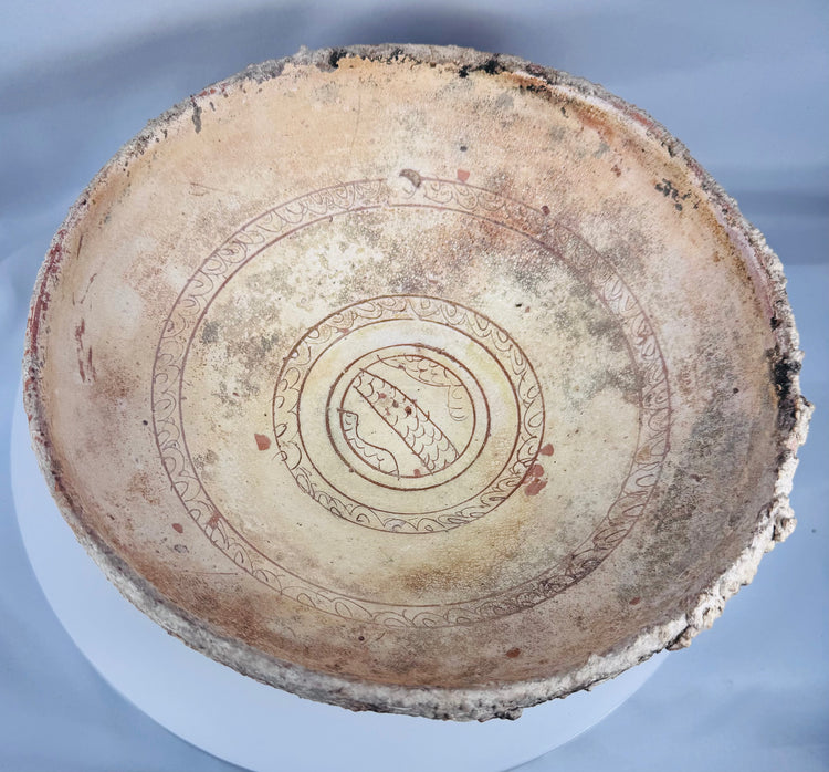 Ancient Eastern Mediterranean ceramic bowl with cream slip decoration and centuries of archaeological weathering.