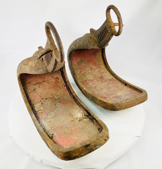 Historic Japanese abumi stirrups crafted for mounted archery, featuring ladder-slotted risers and hand-forged iron construction.
