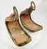 Historic Japanese abumi stirrups crafted for mounted archery, featuring ladder-slotted risers and hand-forged iron construction.