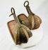 Authentic Japanese samurai stirrups from the Edo period showing original vermilion lacquer interior and remnants of painted scrollwork.