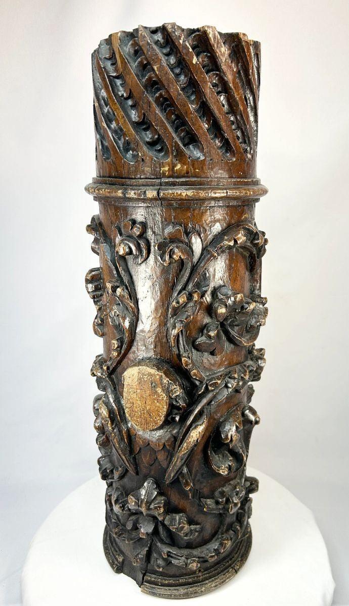 Antique Edo-period Japanese wooden temple pillar fragment, intricately hand-carved with swirling floral motifs and lattice detail, dark brown patina with areas of wear and age exposure, dating to the 18th century, originally part of a Buddhist architectural structure, showcasing traditional craftsmanship and religious artistry.