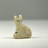 Small faience Bastet amulet from Ancient Egypt with textured earthen deposits and surviving areas of blue-green glazing.
