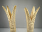 Carved bone lotus and papyrus candlesticks reflecting ancient Egyptian decorative traditions
