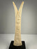 Hand-carved bone candlestick holders with detailed lotus and papyrus forms and aged patina