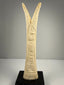 Hand-carved bone candlestick holders with detailed lotus and papyrus forms and aged patina