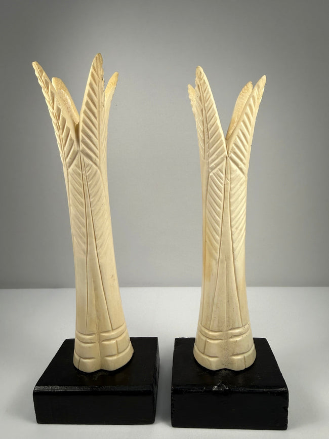 Pair of antique Egyptian-inspired bone candlestick holders mounted on modern black bases