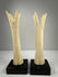 Pair of antique Egyptian-inspired bone candlestick holders mounted on modern black bases