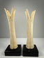 Pair of antique Egyptian-inspired bone candlestick holders mounted on modern black bases