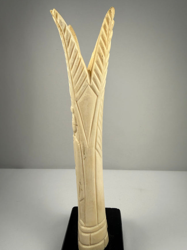 1. Egyptian revival pair of carved bone candlestick holders with preserved detail and black bases