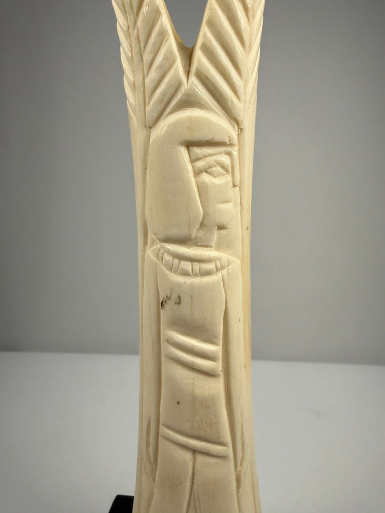 Early 20th-century carved bone candlesticks inspired by ancient Egyptian temple ornamentation