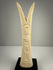 Egyptian revival candlestick holders in carved bone with symbolic floral and plant motifs